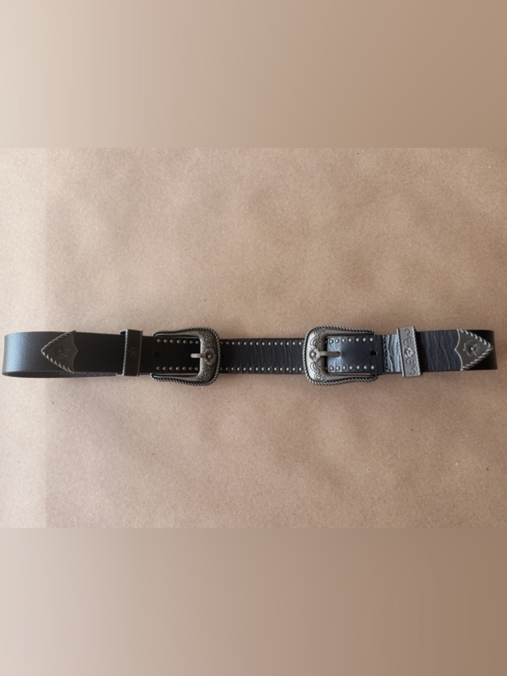 Boutique item with premium craftsmanship and distinctive double buckle design.